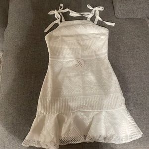 White dress w/ high neckline, adjustable tie straps & an invisible back zipper.